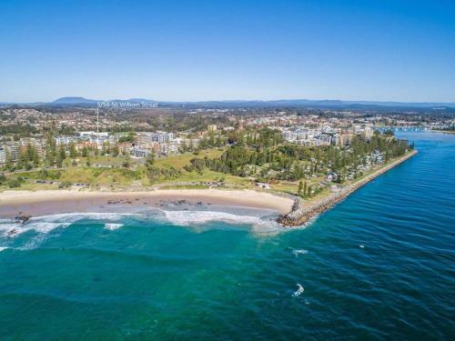 an aerial view of a beach and the ocean at Beachcalmer2 in Port Macquarie