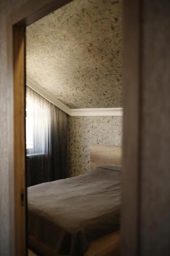 a small bedroom with a bed and a window at Sweet Home in Yengidzha