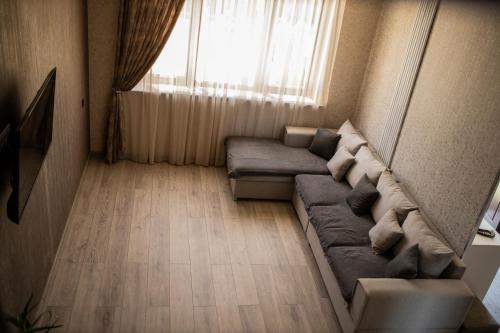 a living room with a couch and a window at Sweet Home in Yengidzha