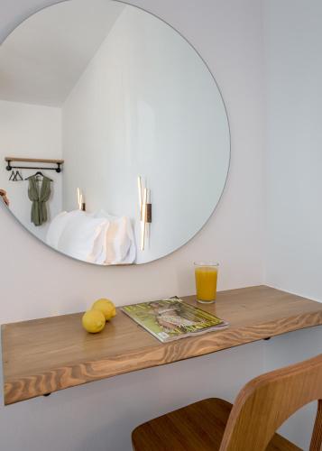 a table with a mirror and a drink on it at Michalis Studios in Pollonia