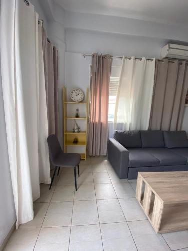 a living room with a couch and a table at Seaside Studio 1 ( 30 meters from the beach ) in Kalamata