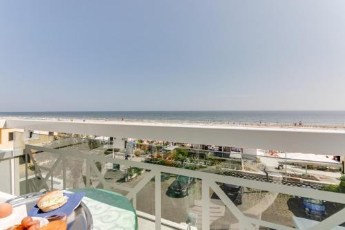 a view of the beach from the balcony of a condo at Hotel Cigno D'Oro in Riccione