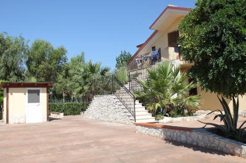a house with a staircase next to a building at Green Park Residence in Foce Varano
