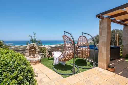 a garden with a view of the ocean at The Stonemade Houses in Falasarna