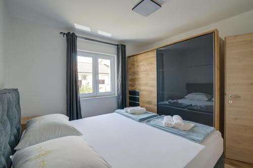 a bedroom with a bed and a large window at FRANKO in Senj