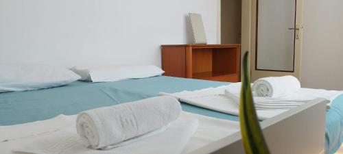 a bedroom with a bed with towels on it at 7 Flower Street Apartment in Šempeter pri Gorici