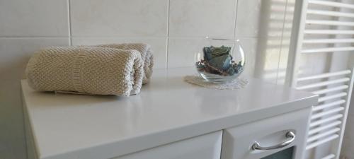 a white counter with a vase on top of it at 7 Flower Street Apartment in Šempeter pri Gorici