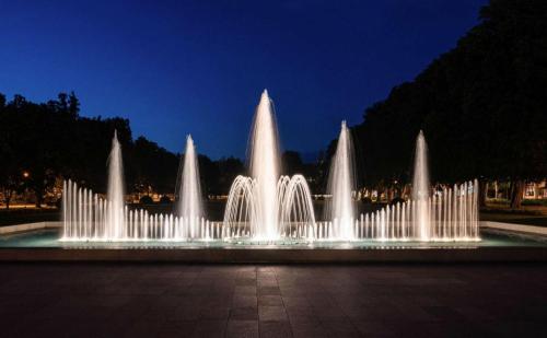 a water fountain in a park at night at Apartment Spa and Fontain Poděbrady in Poděbrady