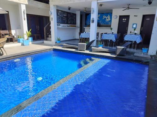 a large swimming pool with blue water in a hotel at Gili Ocean Club - ADULTS ONLY in Gili Trawangan