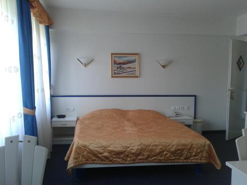1 dormitorio con 1 cama con manta marrón en Hotel Vila Bojana, en Bled