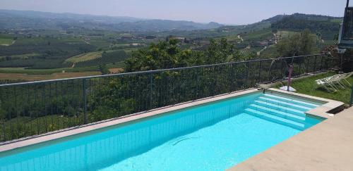 a swimming pool with a view of a mountain at La Vigna Del Parroco in Verduno