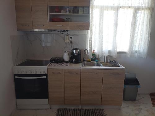 a small kitchen with a stove and a sink at Chania Mini Villas in Skinés