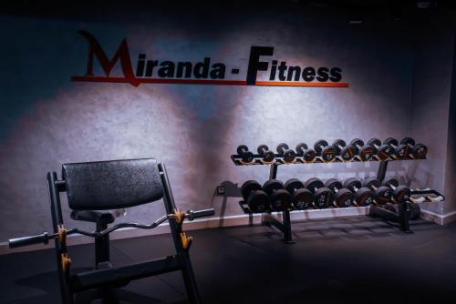 a gym with two rows of dumbbells on a wall at MIRANDA HOTEL - Tanger in Tangier