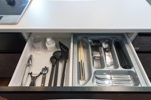 a drawer filled with utensils in a kitchen at クリスタルヴィラ南城 in Azama