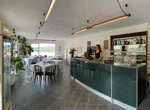 a woman standing at the counter of a restaurant at Villaggio RTA Borgoverde in Imperia