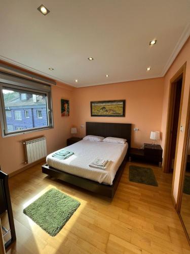 a bedroom with a bed and a large window at Salinas al Mar in Salinas