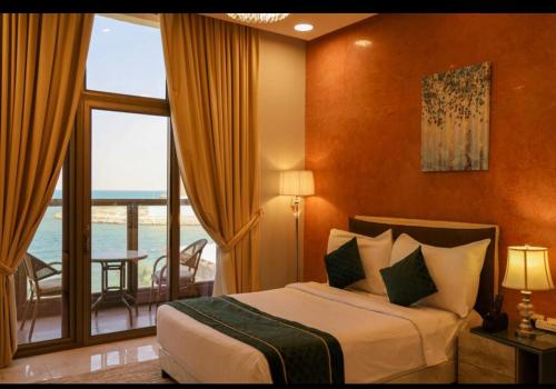 a bedroom with a bed and a large window at Tamara Beach Resort, Al Khobar Half Moon Bay-"Families Only" in Half Moon Bay