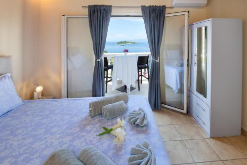a bedroom with a bed with a view of the ocean at Villa Avgerini Paxos in Gaios