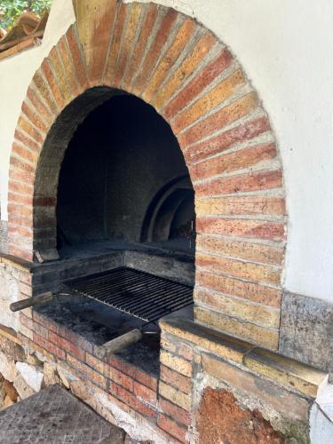 a brick oven with a grill inside of it at Baglio Mazzara in Custonaci
