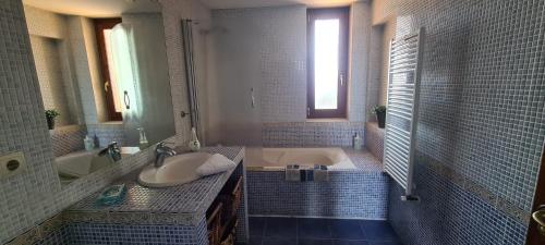 a bathroom with a tub and a sink and a bath tub at MARGASOL in Pedrezuela