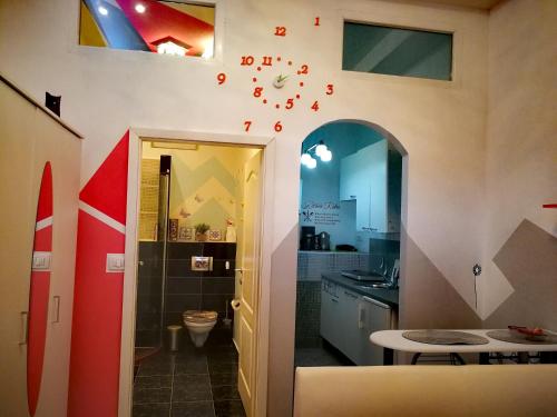 a bathroom with a sink and a clock on the wall at Apartments Anita in Crikvenica