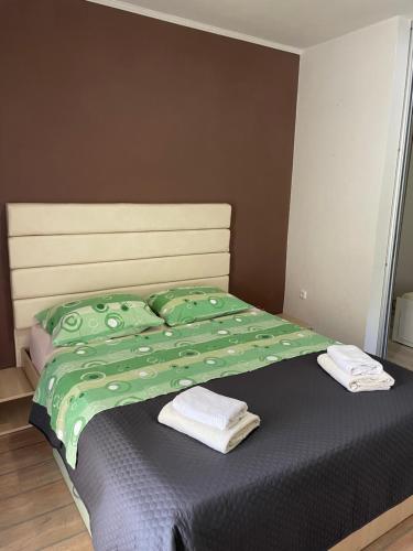 a bedroom with a bed with two towels on it at apartment IVA in Supetarska Draga