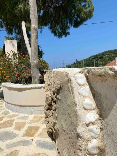 a stone wall with a tree in the background at Villa Antonia in Alikanas