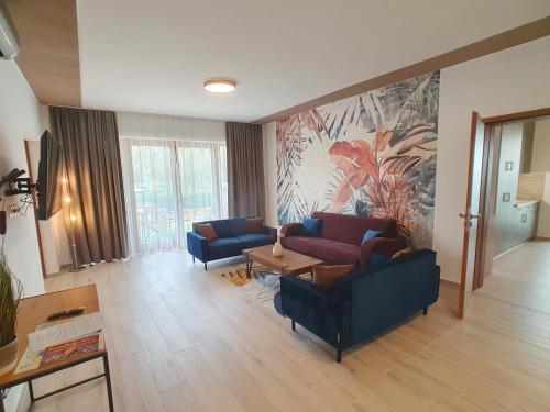a living room with two couches and a table at Alison Apartments (Nr. 24) in Keszthely