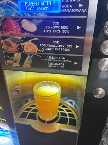 a vending machine with a glass of orange juice at Baltic Sun SPA in Rewal