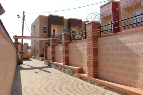 a row of brick buildings on a street at Lovely 2-Bed Apartment in Kampala in Kampala