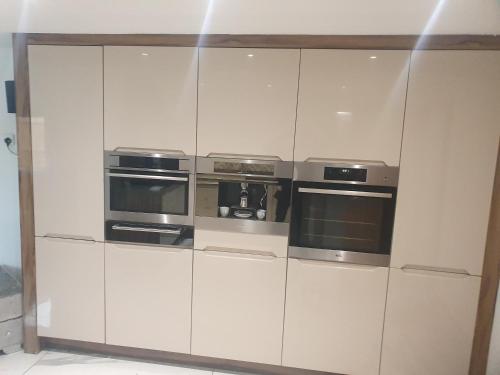 a white cabinet with four ovens in it at The hawthorns large detached 3 bedroom family home in Seaham