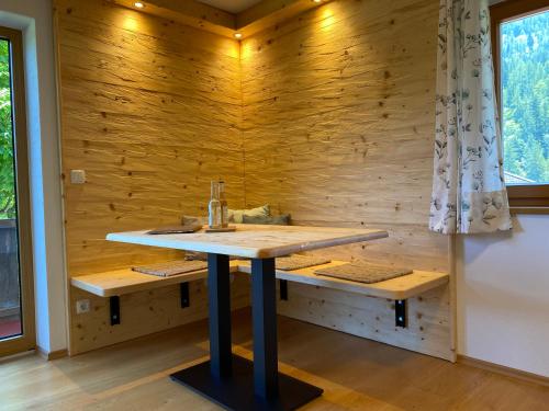 a bathroom with a sink in a wooden wall at Wimbachlehen in Ramsau