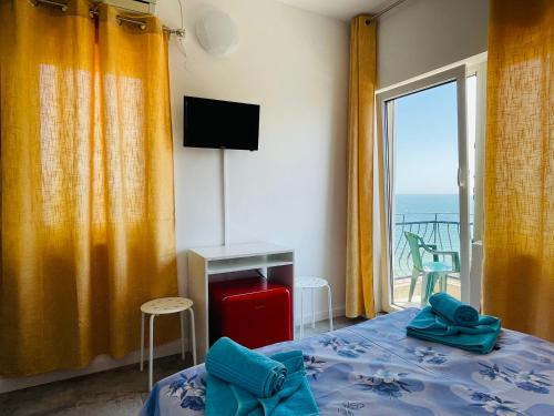 a bedroom with a bed and a view of the ocean at PIERRE 3 la Tarmul MARII -primim Vouchere Vacanta in Costinesti