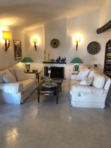 a living room with two white couches and a coffee table at Esclusiva villa sul mare Tropea in Parghelia
