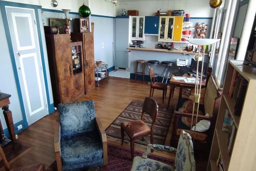 a living room with a table and chairs and a kitchen at Logement entier, vue, Paris centre, Catacombes in Paris