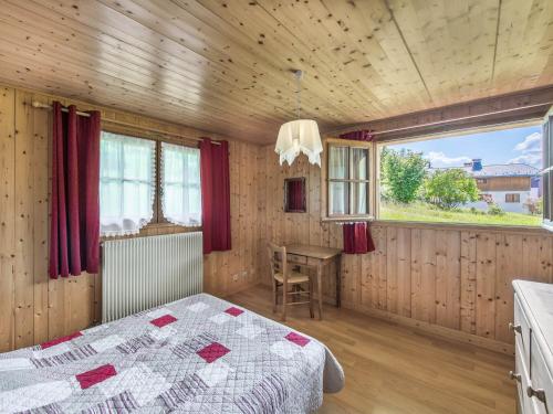 a bedroom with a bed and a table and a window at Chalet Megève, 5 pièces, 8 personnes - FR-1-453-233 in Megève