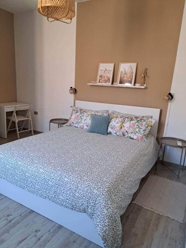 a bedroom with a large bed with pillows at CINQUE TORRI AFFITTACAMERE in Osimo