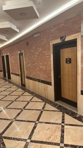 a hallway with three doors in a brick wall at ريف الشرق للشقق الفندقية in Al Madinah
