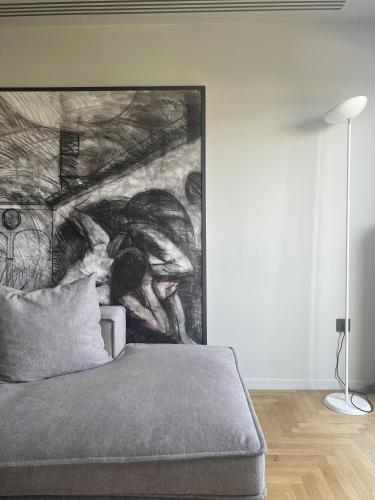 a bedroom with a large painting on the wall at Athens Central Apartment in Athens