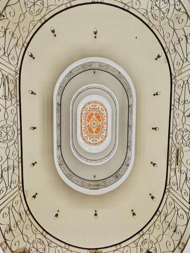 a white plate on a ceiling in a room at Al Ayjah Plaza Hotel in Sur