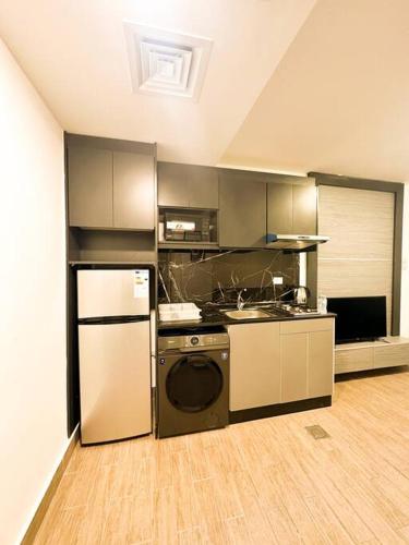 a kitchen with a stove and a refrigerator at central apartment for rent 26 in Umm Uthainah