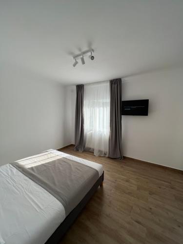 um quarto branco com uma cama e uma janela em Nord 22 em Constança