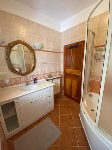 a bathroom with a sink and a mirror and a shower at VİLLA MARMARİS in Marmaris