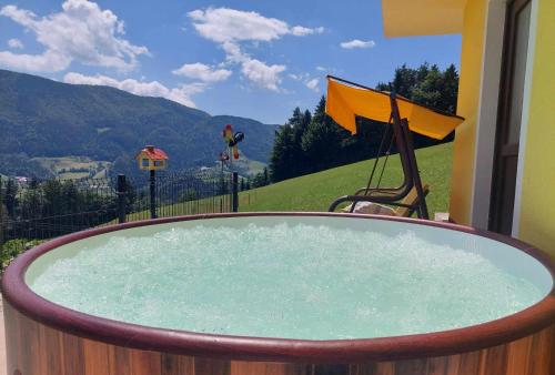 a hot tub with a view of a mountain at Sunflower House with SPA and Sauna in Vitanje