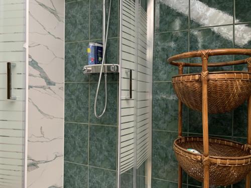 a bathroom with a shower with a basket at EDEN Apartment in Sveta Nedjelja