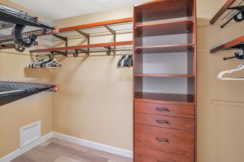 a walk in closet with wooden cabinets and shelves at Paradise with a pool, pier and private beach area in Osprey