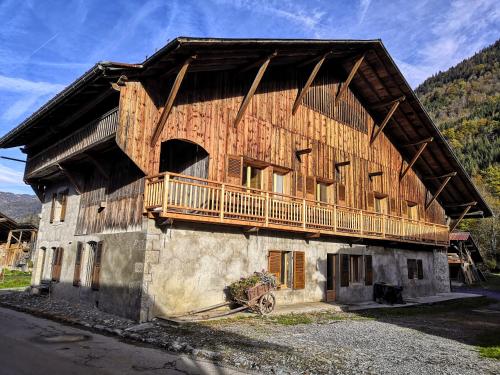 um grande edifício de madeira com uma varanda em Chez Lucienne em Samoëns