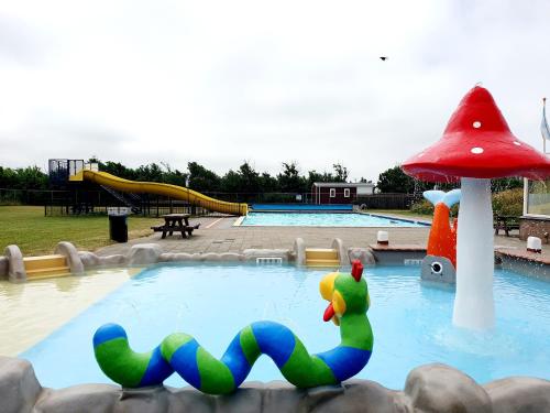 a swimming pool with a toy in the water at Sandy Feet Retreat in Petten
