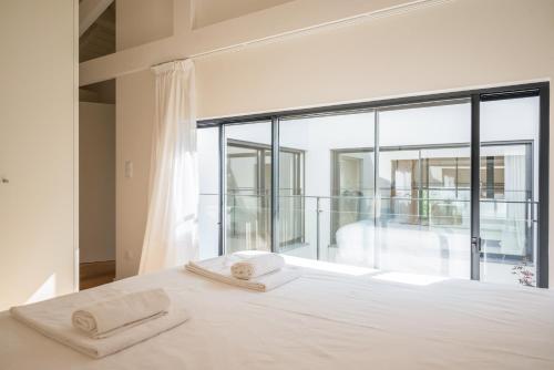 a bedroom with a bed and a large window at Loft in Porto in Porto