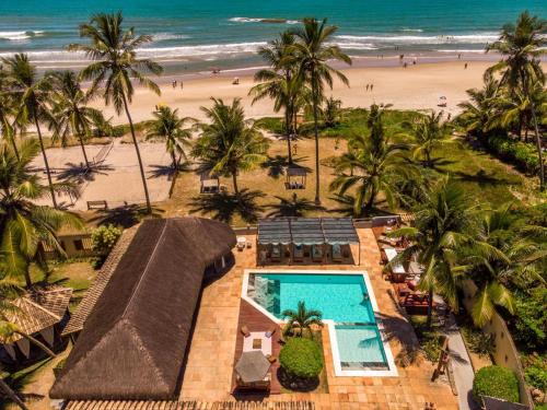 an aerial view of a resort with a beach at Pousada dos Hibiscus in Ilhéus